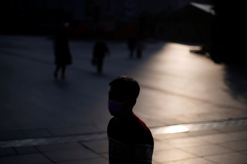 A man wearing a mask is seen at the Shanghai railway station in Shanghai