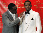 Sean "Diddy" Combs touches his wax figure at Madame Tussauds in New York, December 15, 2009. REUTERS/Shannon Stapleton