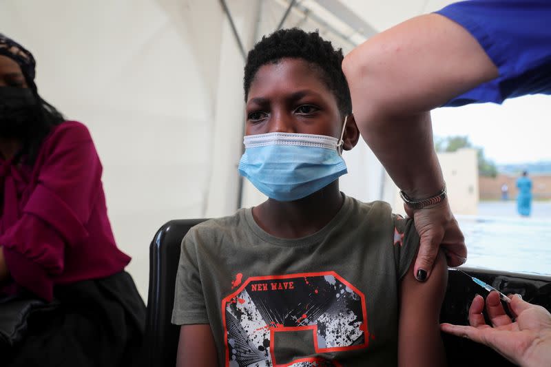 Healthcare worker administers the Pfizer coronavirus disease (COVID-19) vaccine to Simphiwe, 13, in Johannesburg