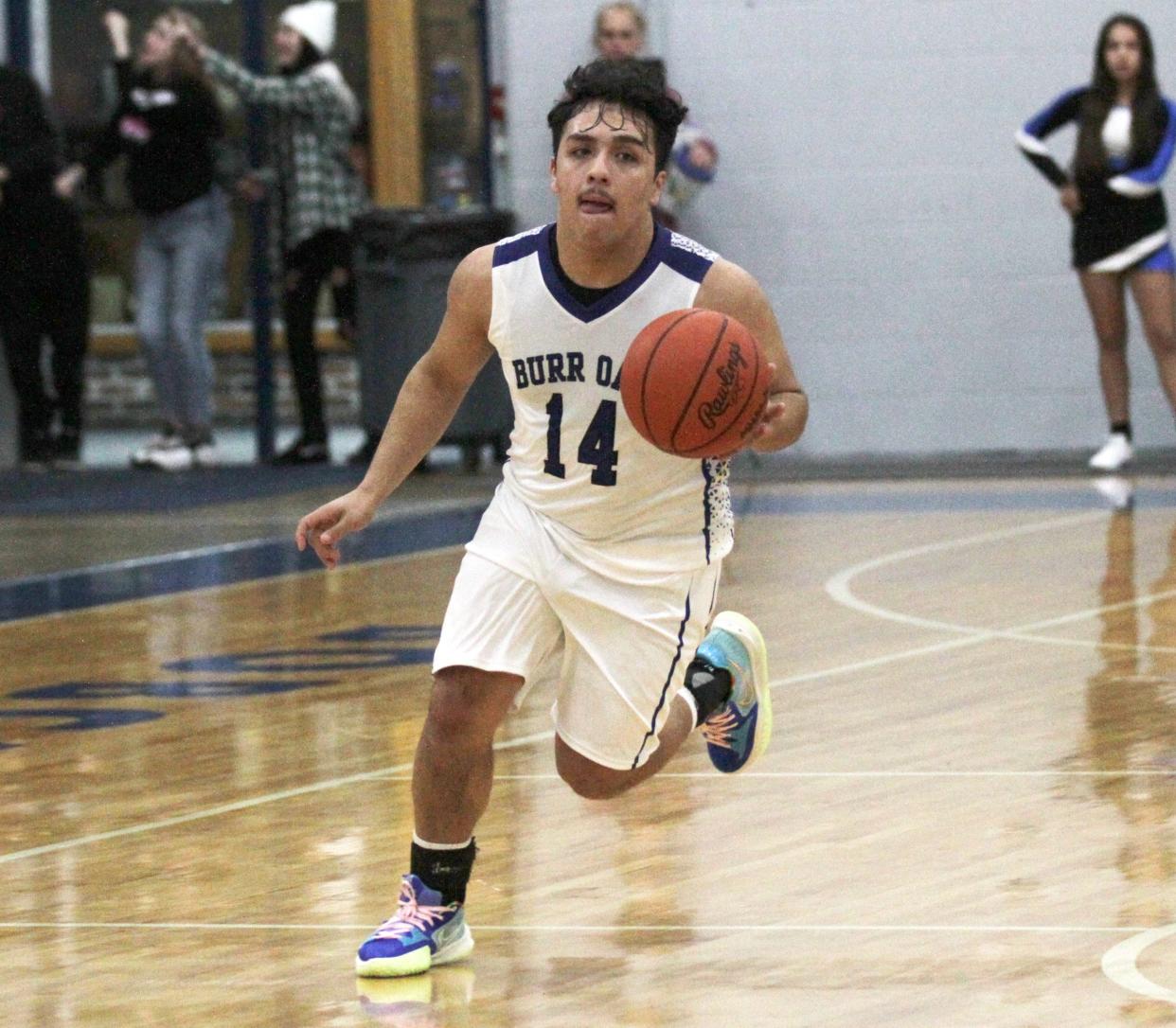 Branson Hernandez pushes the ball up the floor for Burr Oak against Athens on Tuesday.