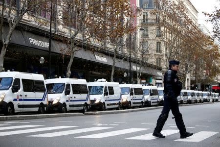 FILE PHOTO: French CRS riot police vehicles stand in place along the Printemps Department store during a national day of protest by the "yellow vests" movement in Paris, France, December 8, 2018. REUTERS/Stephane Mahe/File Photo