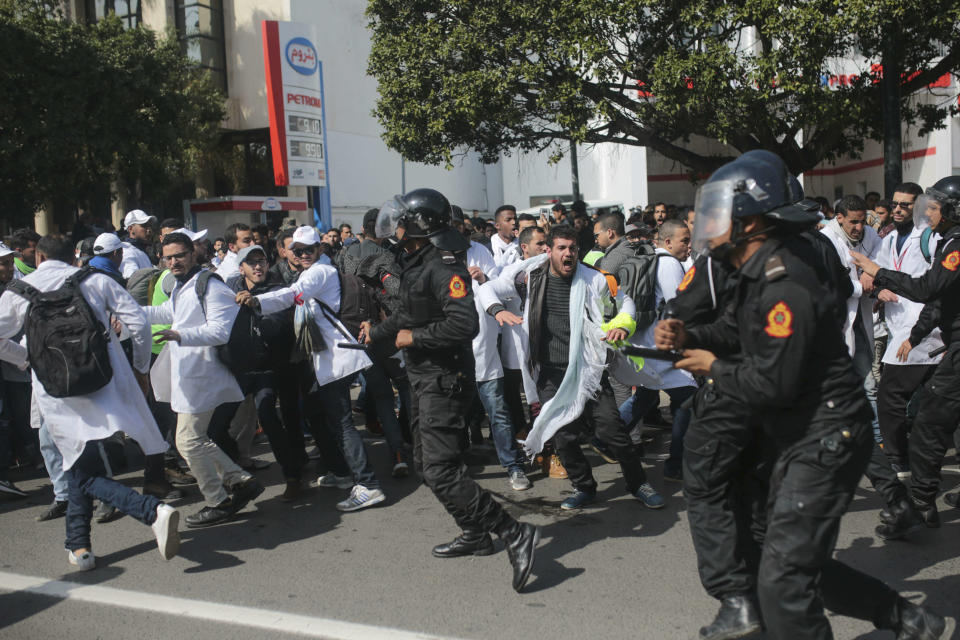 Security forces charge at protesting teachers during a demonstration in Rabat, Morocco, Wednesday, Feb. 20, 2019. Moroccan police fired water cannons at protesting teachers who were marching toward a royal palace and beat people with truncheons amid demonstrations around the capital Wednesday. (AP Photo/Mosa'ab Elshamy)