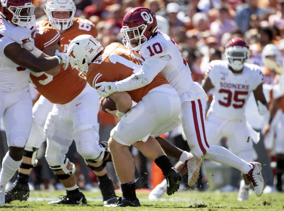 Oklahoma safety Pat Fields (10) sacks Texas quarterback Sam Ehlinger (11) in the first half of an NCAA college football game at the Cotton Bowl, Saturday, Oct. 12, 2019, in Dallas. (AP Photo/Jeffrey McWhorter)