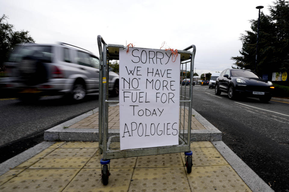 A sign referring to the lack of fuel is placed at the entrance to a petrol station in London, Tuesday, Sept. 28, 2021. Long lines of vehicles have formed at many gas stations around Britain since Friday, causing spillover traffic jams on busy roads. (AP Photo/Frank Augstein)