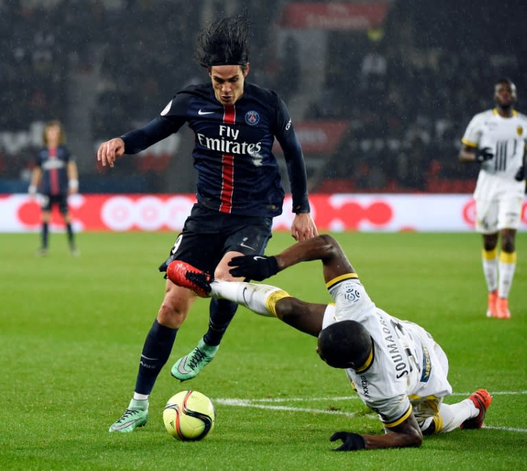 Paris Saint-Germain's forward Edinson Cavani (L) vies for the ball with Lille's defender Adama Soumaoro during the French L1 match at the Parc des Princes stadium in Paris, on February 13, 2016