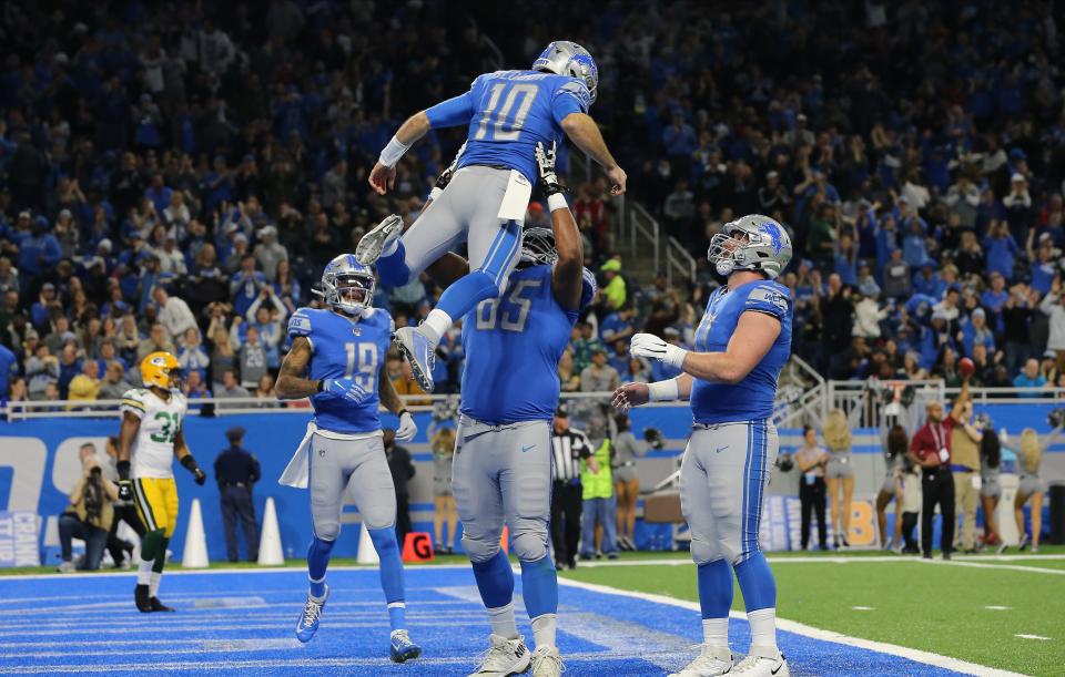 DETROIT, MI - DECEMBER 29: David Blough #10 of the Detroit Lions celebrates his first quarter touchdown catch with Tyrell Crosby #65 of the Detroit Lions against the Green Bay Packers  at Ford Field on December 29, 2019 in Detroit, Michigan. (Photo by Rey Del Rio/Getty Images)