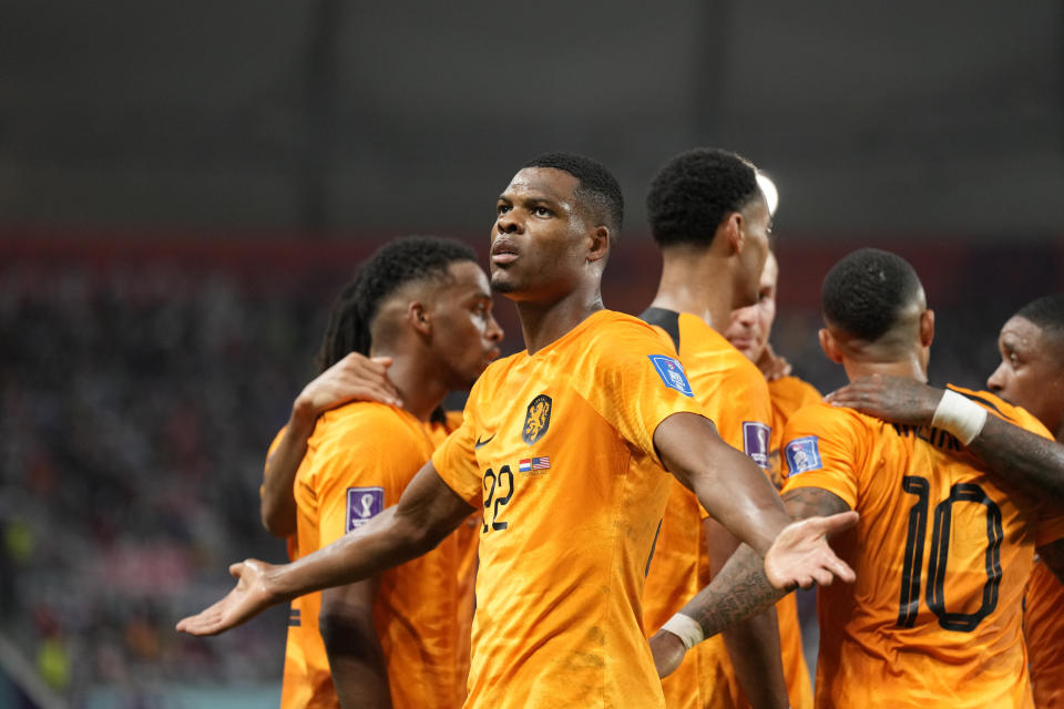 Denzel Dumfries of the Netherlands celebrates scoring his side's 3rd goal during the World Cup round of 16 soccer match between the Netherlands and the United States, at the Khalifa International Stadium in Doha, Qatar, Saturday, Dec. 3, 2022. (AP Photo/Ashley Landis)