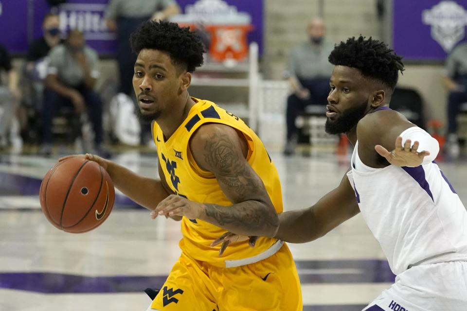 FILE - West Virginia guard Taz Sherman, left, works against TCU's Mike Miles, right, in the first half of an NCAA college basketball game in Fort Worth, Texas, in this Tuesday, Feb. 23, 2021, file photo. Sherman is the top returning scorer this season on a team with seven newcomers, including three graduate transfers. (AP Photo/Tony Gutierrez, File)