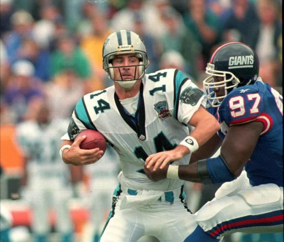 Panthers quarterback Frank Reich (14) is sacked by Giants defensive end Robert Harris (98) during the first quarter of Carolina’s 6-3 win over New York Saturday, Aug. 27, 1995 at Clemson Memorial Stadium.