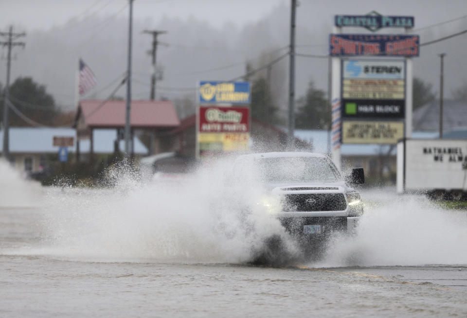 Heavy rain causes high water and flooding along Highway 101 in Tillamook, Ore., on Tuesday, Dec. 5, 2023. (Dave Killen/The Oregonian via AP)