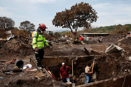 Mamerto Alvarez rests as he continues looking for his family in an area affected by the eruption of the Fuego volcano in San Miguel Los Lotes in Escuintla, Guatemala June 13, 2018. REUTERS/Carlos Jasso