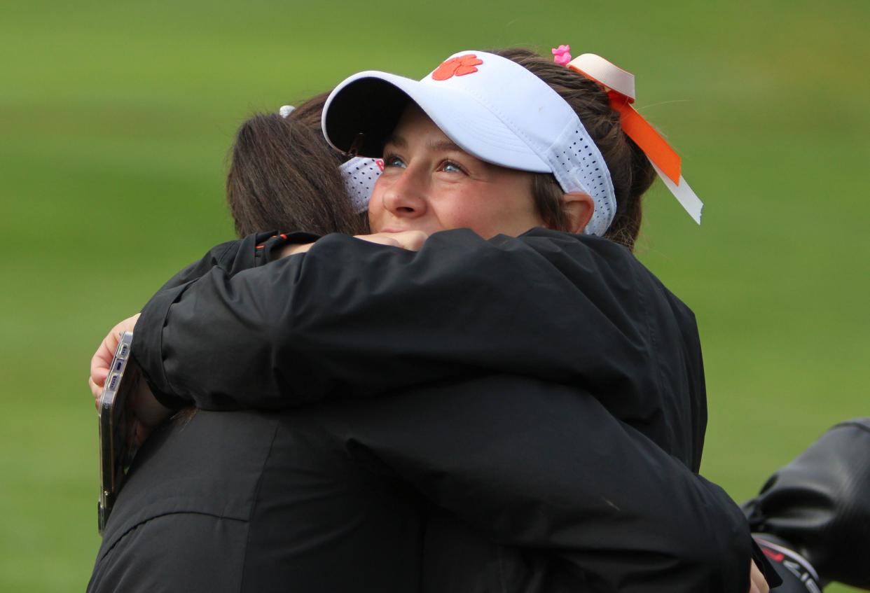 Brighton's Abbie Pietila (right) hugs teammate Maddy Martens during the state Division 1 golf tournament Saturday, Oct. 21, 2023 at Forest Akers West in East Lansing.