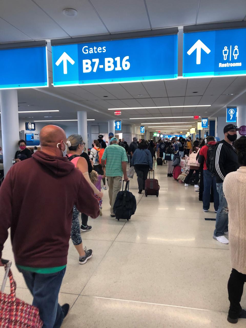 Travelers wear face masks at a busy American Airlines concourse at Charlotte-Douglas International Airport in November.