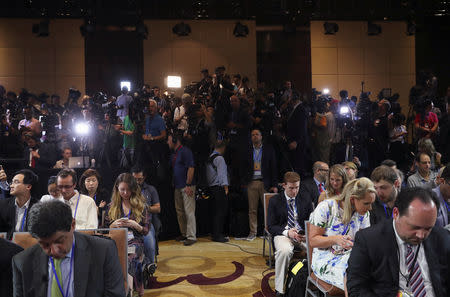 FILE PHOTO - Members of the media prepare ahead of a news conference by U.S. President Donald Trump after his summit with North Korean leader Kim Jong Un at the JW Marriott hotel in Hanoi, Vietnam, February 28, 2019. REUTERS/Leah Millis/File Photo