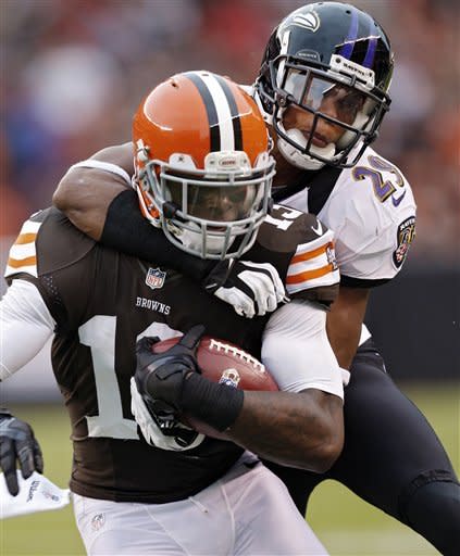 Cleveland Browns wide receiver Josh Gordon, left, is tackled by Baltimore Ravens cornerback Cary Williams (29) in the fourth quarter of an NFL football game in Cleveland, Sunday, Nov. 4, 2012. (AP Photo/Rick Osentoski)