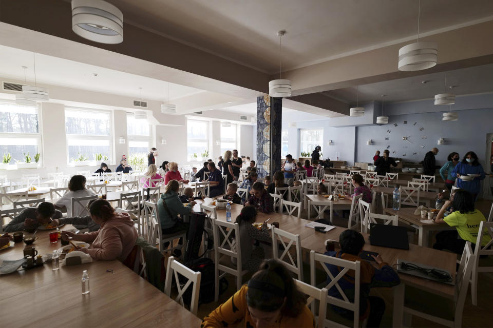 Children eat lunch at a clinic in Bocheniec, Poland, on Thursday, March 17, 2022. More than 500 Ukrainian children with cancer have been evacuated so far to a clinic in Poland. They are evaluated by doctors who then decide where they should go next for treatment. Some 200 hospitals in about 28 countries are accepting the children. (AP Photo/Pawel Kuczynski)