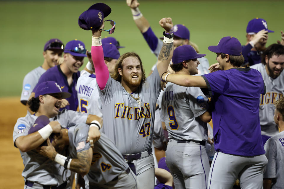FILE - LSU infielder Tommy White (47) celebrates with his team after defeating Kentucky in an NCAA college baseball tournament super regional game in Baton Rouge, La., Sunday, June 11, 2023. LSU won 8-3. The third baseman is the Division I active career leader in home runs with 51 in two seasons. (AP Photo/Tyler Kaufman, FIle)