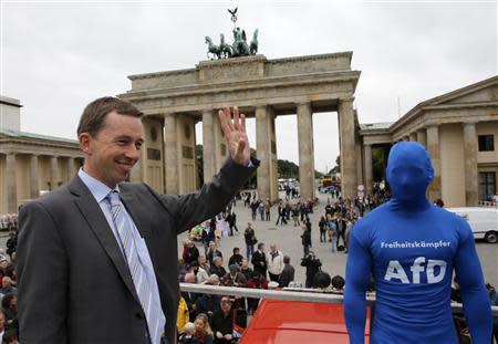 The leader of the euro-critical Alternative for Germany party Bernd Lucke waves in front of the Brandenburg Gate during an election campaign in Berlin September 16, 2013. German voters will go to the polls in a general election on September 22. REUTERS/Fabrizio Bensch