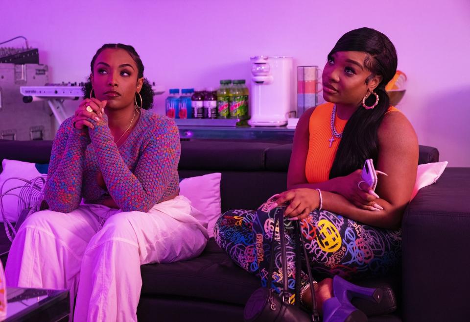 Shawna (Aida Osman) and Mia (KaMillion) sit on a couch in season 2 episode 1 of Rap Sh!t