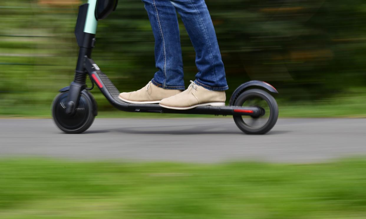 <p>The government is trialing an e-scooter rental scheme in cities across the UK</p> (AFP via Getty Images)