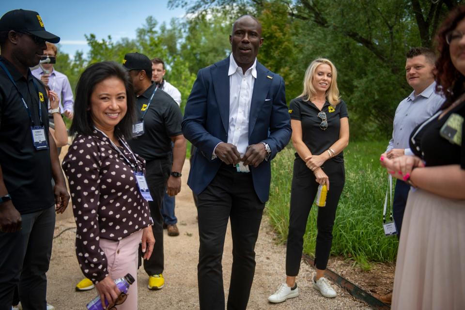 NFL Hall of Fame member Terrell Davis, center, waits to speaks at the 2022 Connect Conference at Encompass Technologies in Fort Collins on Thursday.