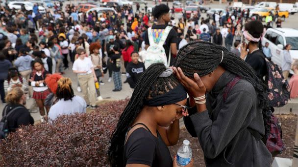 PHOTO: Students stand in a parking lot near the Central Visual & Performing Arts High School after a reported shooting at the school in St. Louis, on Oct. 24, 2022. (David Carson/St. Louis Post-Dispatch via AP)