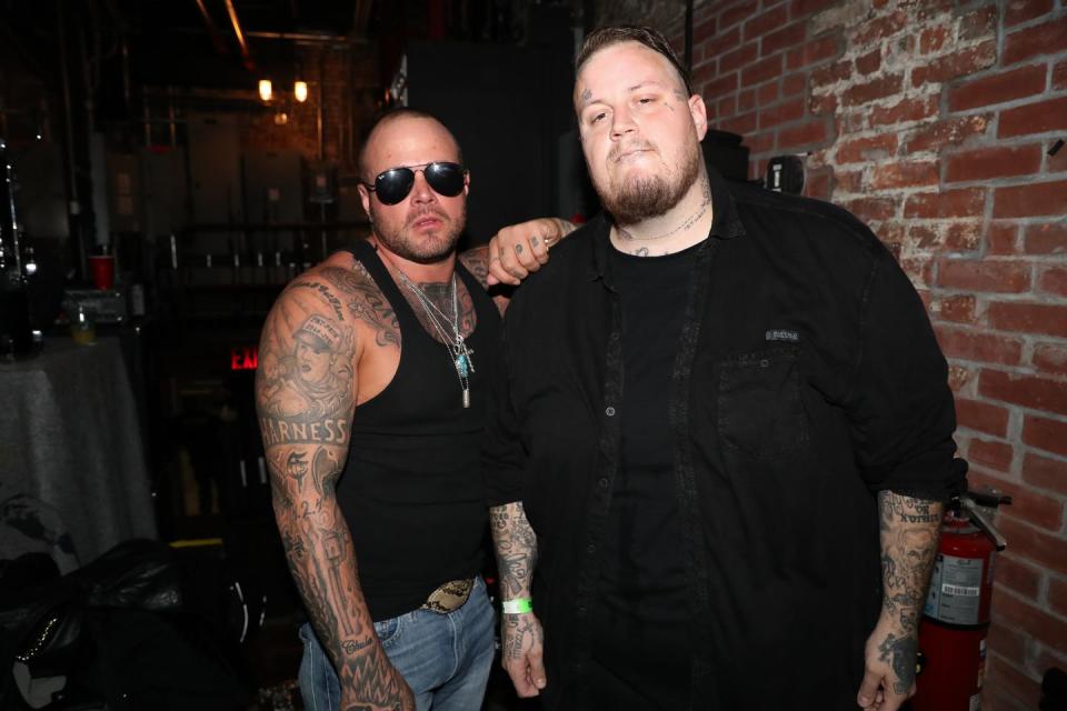 struggle jennings and jelly roll posing in a backstage area at a concert