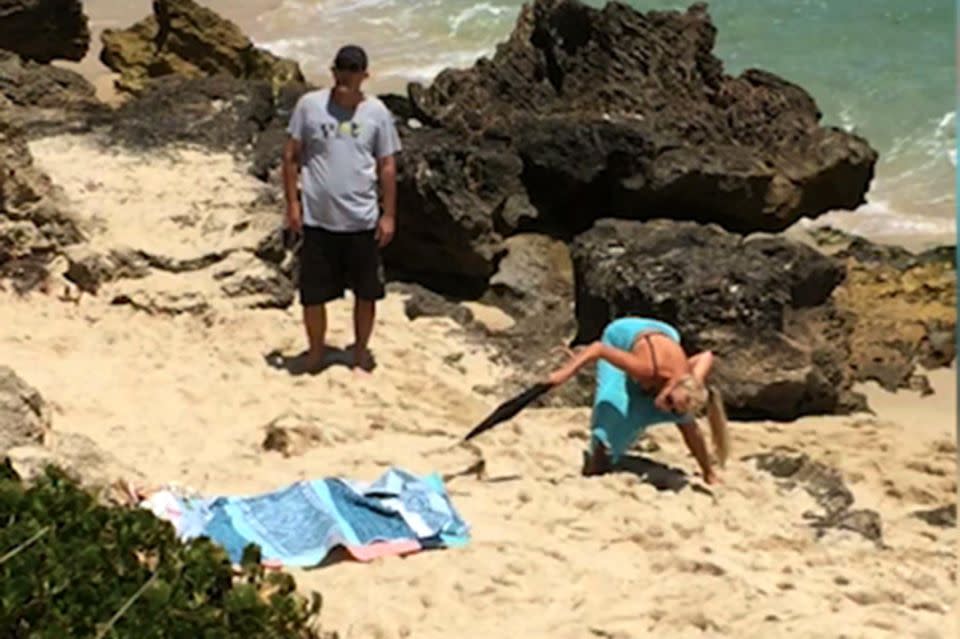 A shocked woman finds a snake under her beach towel. Photo: Caters News