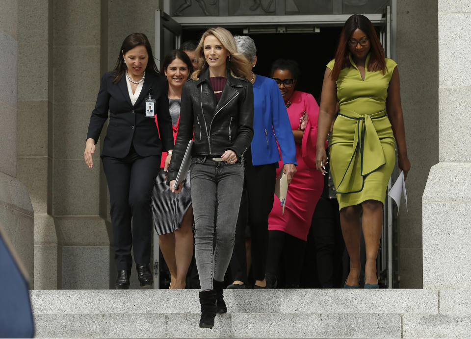 FILE -- In this April 1, 2019 file photo California first partner Jennifer Siebel Newsom, center, the wife of Gov. Gavin Newsom, descends the steps of the Capitol for a news conference to announce the #EqualPayCA campaign, in Sacramento, Calif. She has shunned the traditional title of "first lady" and is focusing on women's issues including equal pay and expanding family leave. (AP Photo/Rich Pedroncelli, File)