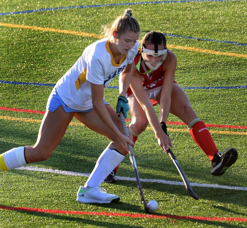 Grace Wiggins of Cape Henlopen (left) tries to get the ball upfield past Smyrna's Bree Moffett on Sept. 14. Both players are ranked among the best in Delaware high school field hockey by the state's coaches.