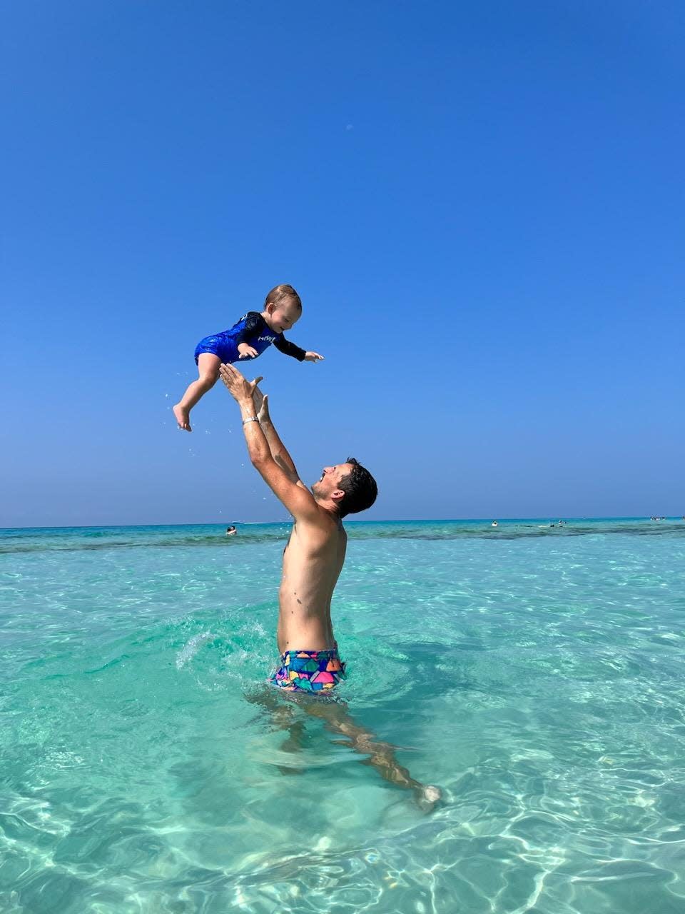 Sports editor Seth Stringer tosses his son, Wyatt, into the air on a recent visit to the beach.