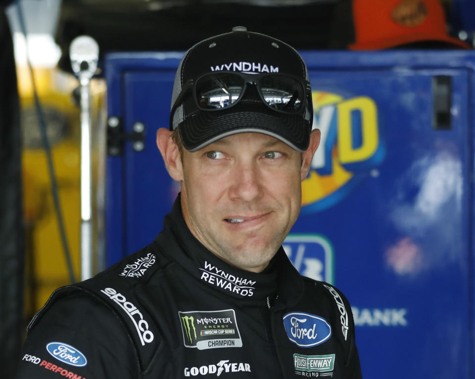 FILE - In this May 11, 2018, file photo, driver Matt Kenseth stands in the garage area before a practice run for a NASCAR Cup Series auto race at Kansas Speedway in Kansas City, Kan. NASCAR's driver carousel will spin long after the season finale. Former Cup champions Kenseth and Kurt Busch, and Daniel Suarez, AJ Allmendinger, Regan Smith and Jamie McMurray are among the drivers certain to start next season with new teams or new roles. (AP Photo/Colin E. Braley, File)