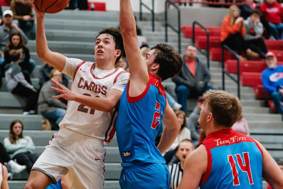 Sandy Valley's Dantae Faiello, left, puts up two points against Garaway during a game, Tuesday, Jan. 23 in Sandyville.