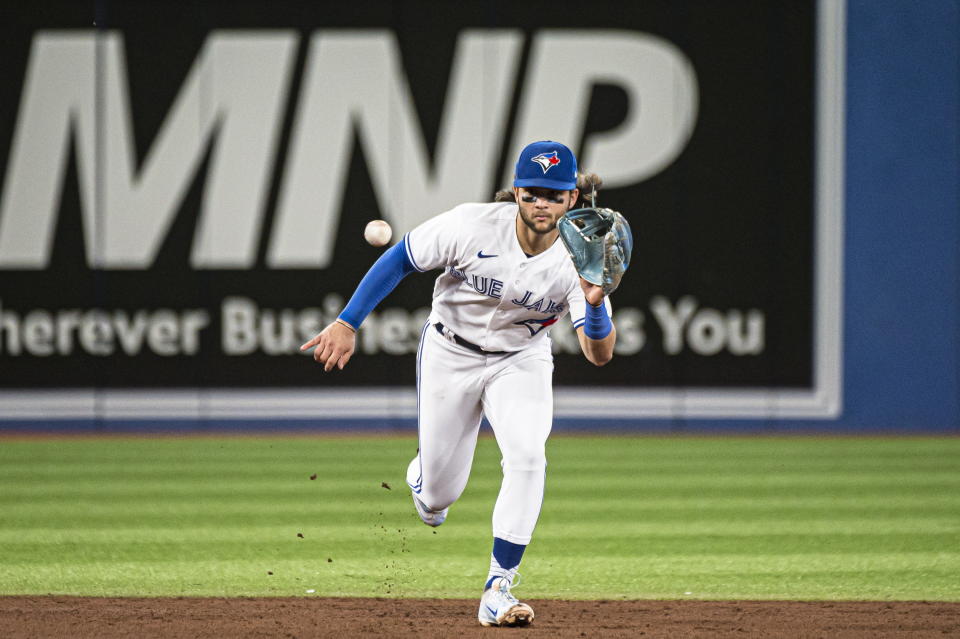 Toronto Blue Jays shortstop Bo Bichette (11) fields a ground ball hit by Baltimore Orioles' Jorge Mateo (3) during the sixth inning of a baseball game in Toronto on Wednesday, Aug. 17, 2022. (Christopher Katsarov/The Canadian Press via AP)