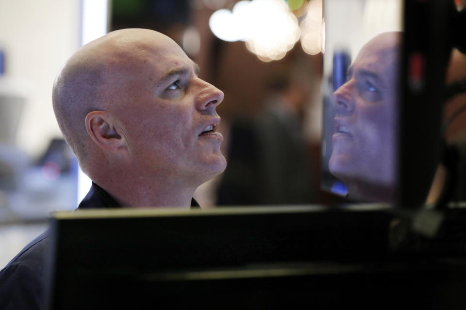 Specialist John O'Hara is reflected in a monitor at his post on the floor of the New York Stock Exchange, Thursday, Dec. 27, 2018. Wall Street's wild Christmas week goes on, with the Dow Jones Industrial Average slumping 300 points at the open Thursday, a day after notching its biggest-ever point gain. (AP Photo/Richard Drew)