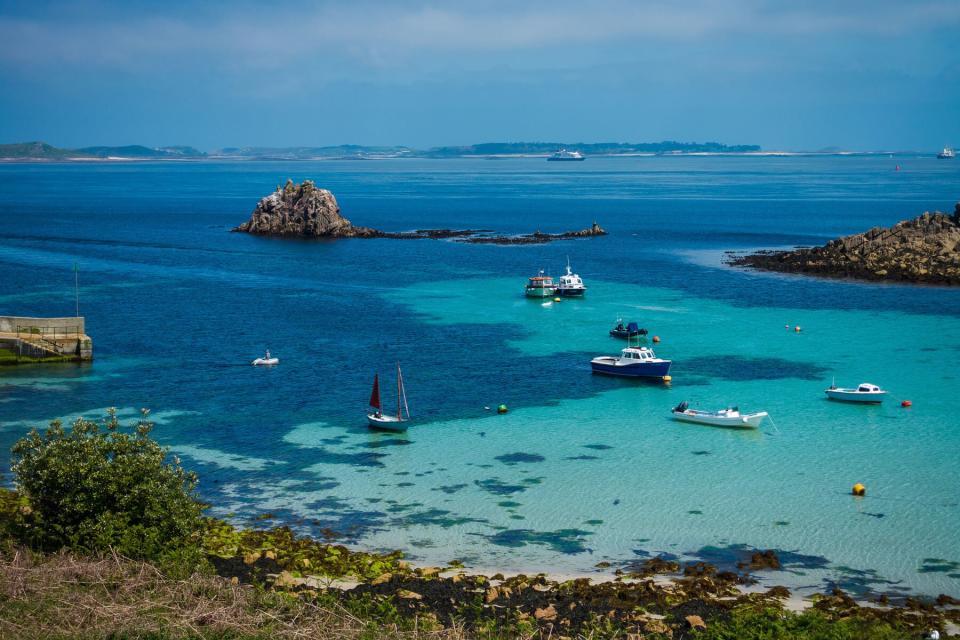 Wide view of St. Agnes, Isles of Scilly, Cornwall, UK. Bright blue waters and sky.