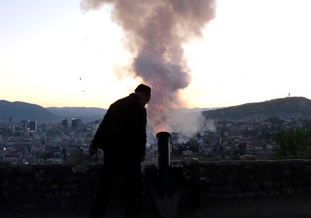 A Ramadan gunner fires a round from his firework cannon to signal the end of dawn-to-dusk fast from an old fortress overlooking the historic center of Sarajevo, Bosnia, Tuesday, May 11, 2021. Muslims throughout the world are marking the last days of Ramadan -- a month of fasting during which observants abstain from food, drink and other pleasures from sunrise to sunset. (AP Photo/Eldar Emric) (Photo: via Associated Press)