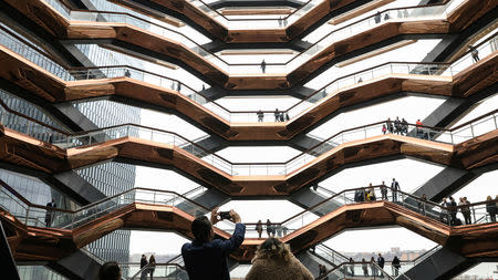 People tour the inside 'The Vessel,' a large public art sculpture made up of 155 flights of stairs, during the grand opening of the The Hudson Yards development, a residential, commercial, and retail space on Manhattan's West side in New York City, New York, U.S., March 15, 2019. REUTERS/Brendan McDermid