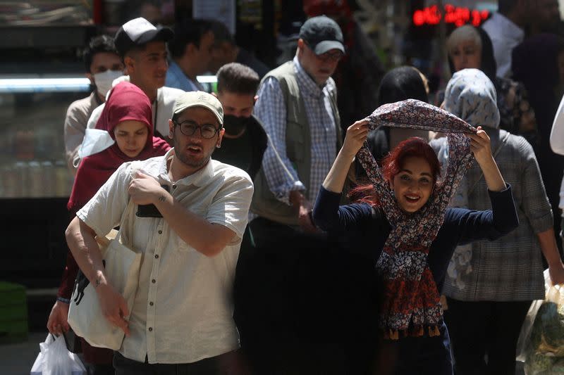 FILE PHOTO: People walk on a street amid the implementation of the new hijab surveillance in Tehran