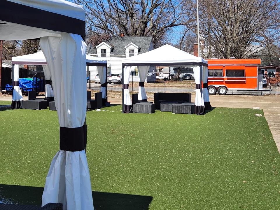 Pavilions with seating, a turfed area for games and one of two permanent food trucks can be seen at Uptown Eatery on Saturday, March 12, 2022.