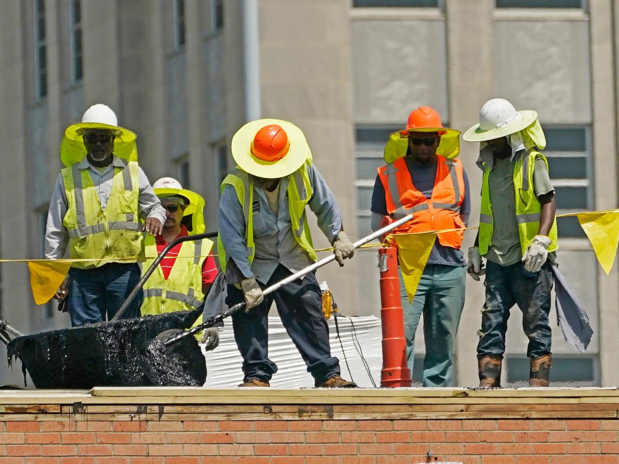 workers on a roof with wide brimmed hats neck covers