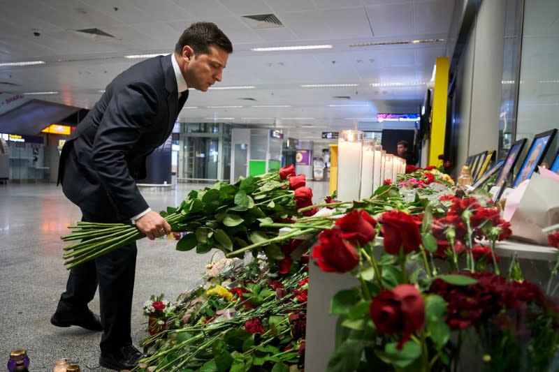 Ukrainian President Volodymyr Zelenskiy lays flowers to commemorate victims of the Ukraine International Airlines Boeing 737-800 plane crash, at a memorial in Boryspil International airport