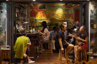 In this Oct. 7, 2020 photo, customers sit at Club 71 in Hong Kong. The bar known as a gathering place for pro-democracy activists and intellectuals is closing. For years, the storied bar has served as a watering hole for the city’s pro-democracy activists and intellectuals, who could freely engage in discussions over a round of beer or two. (AP Photo/Vincent Yu)