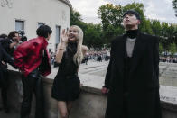 V, from left, Lisa, and Park Bo-gum greet crowds before the Celine men's Spring Summer 2023 collection presented in Paris, France, Sunday, June 26, 2022. (AP Photo/Francois Mori)