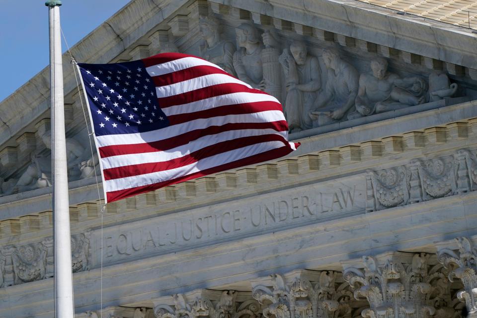 An American flag waves in front of the Supreme Court building, Nov. 2, 2020, on Capitol Hill in Washington.