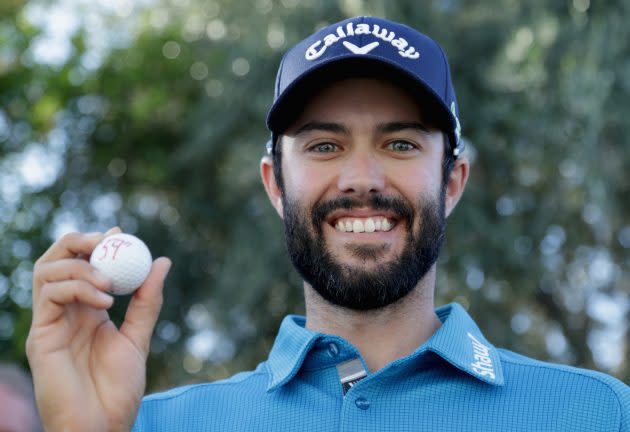 Adam Hadwin holds up his ball