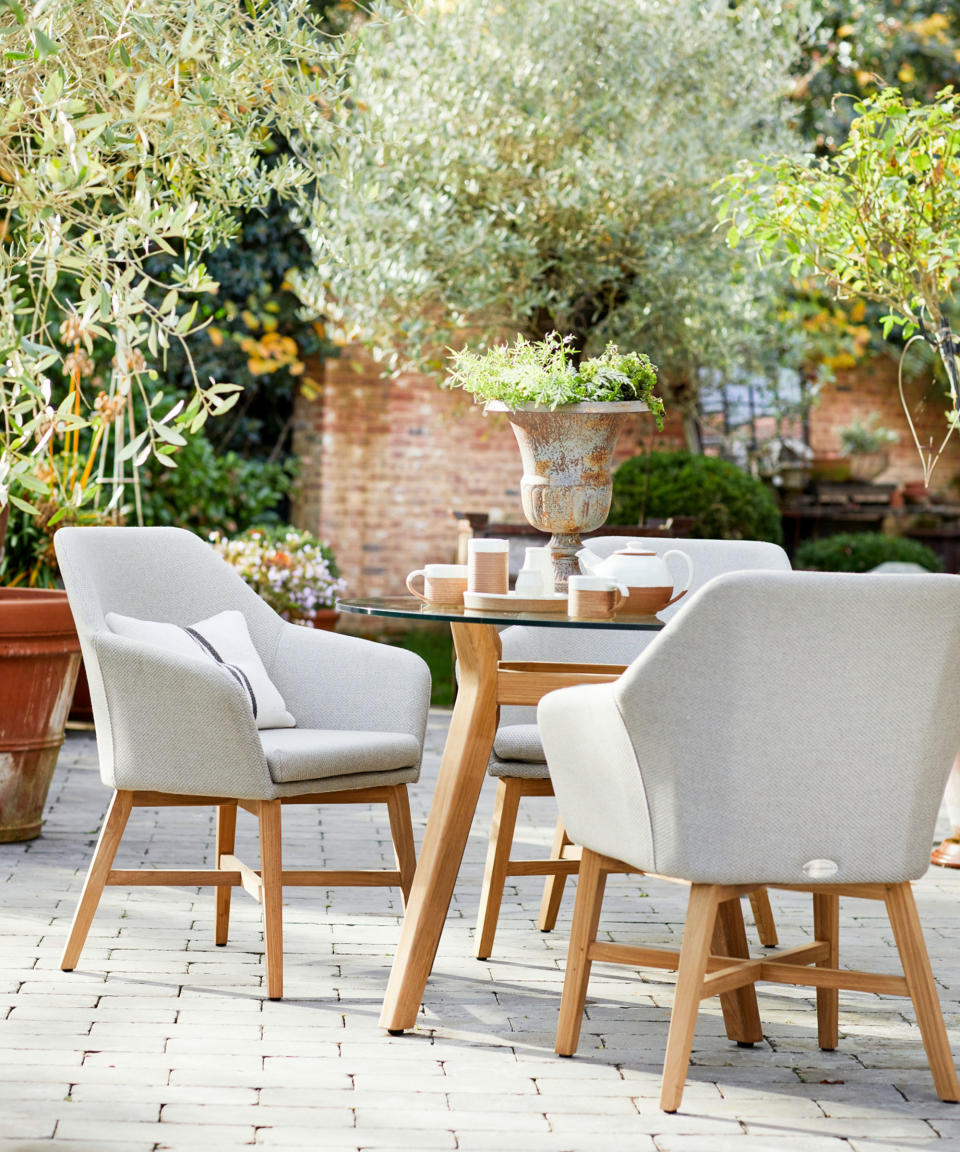 teak outdoor dining furniture on a patio