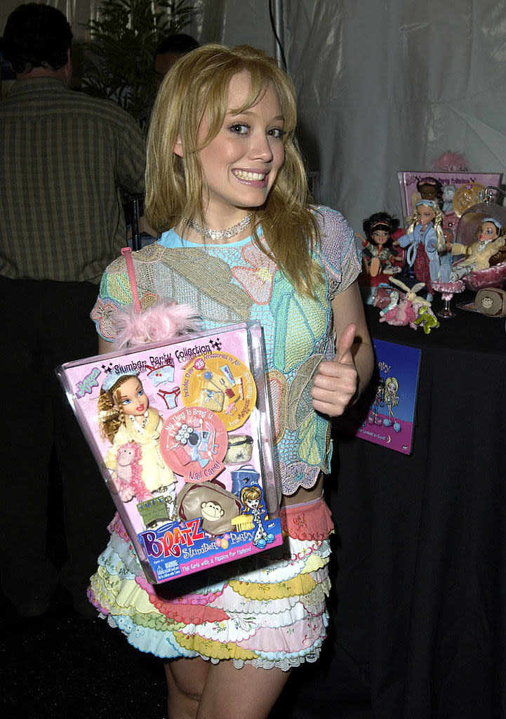 Hilary smiling and holding a Bratz Slumber Party Collection package