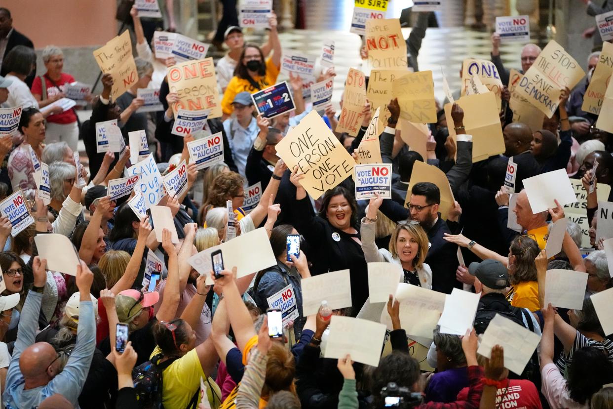 May 10, 2023; Columbus, Ohio, USA;  House Minority Leader Allison Russo speaks with protesters in the rotunda of the Ohio Statehouse with fellow Democrat representatives holding up hand-drawn signs on manilla folders chanting “one person one vote” following a vote on whether to create an August special election for a resolution that would increase the voter threshold to 60 percent for constitutional amendments. Mandatory Credit: Adam Cairns-The Columbus Dispatch