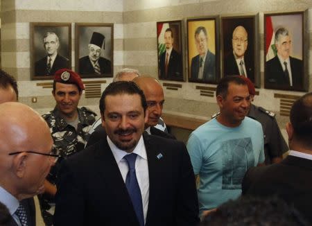 Lebanon's Prime Minister Tammam Salam (L) walks with former prime minister Saad al-Hariri (C) at the government's headquarters in Beirut August 8, 2014. REUTERS/Georges Farah